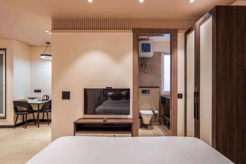 Bedroom with wall-mounted TV and en-suite bathroom