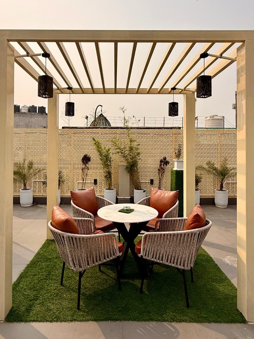 Rooftop pergola seating area with lounge chairs