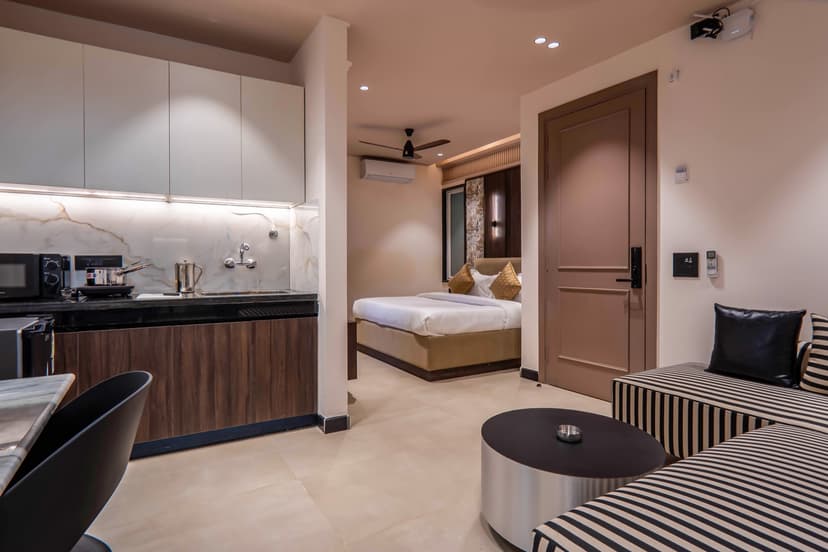 Studio suite with kitchenette, bedroom, and lounge seating